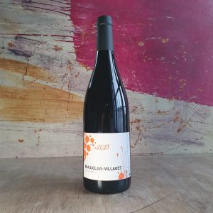 A bottle of red wine made by Alex Foillard. The label is white and orange with the text '2021 Beaujolais-Villages' printed on it
